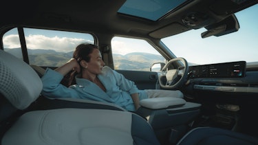 Eine Frau sitzt im Cockpit des Kia EV3
