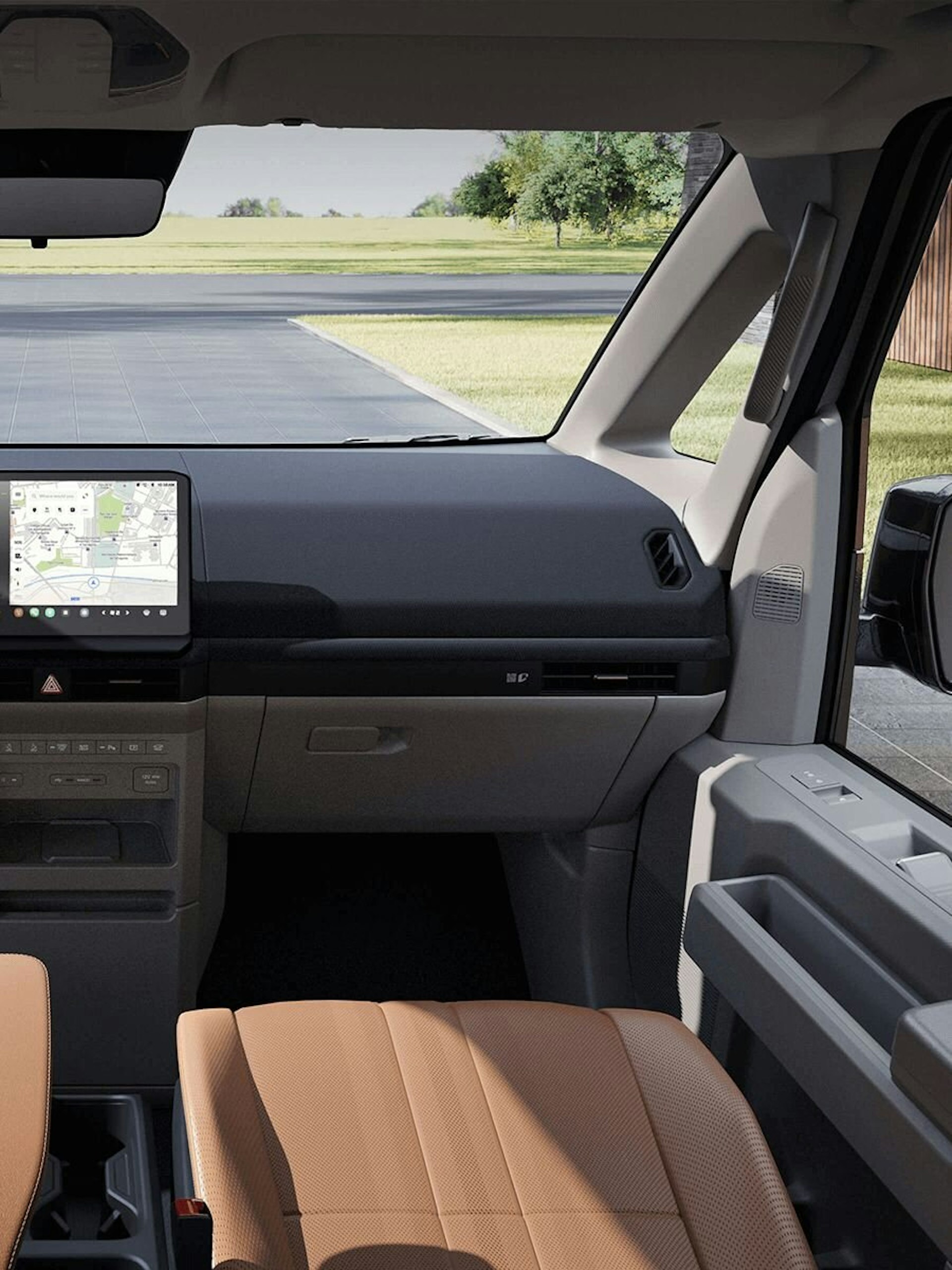 Innenansicht vorne des Kia PV5 Passenger mit mehreren versteckten Staufächern im Fahrer- und Beifahrerbereich